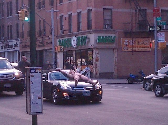 Naked woman tied to hood of car