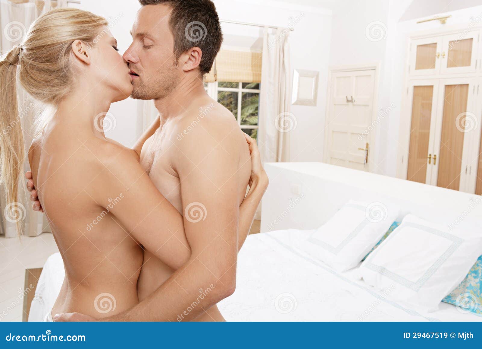 Nude couple hugging and kissing