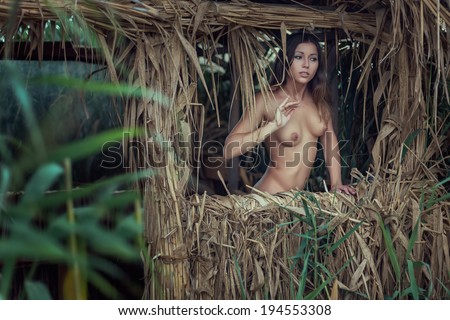 Nude girl straw hut
